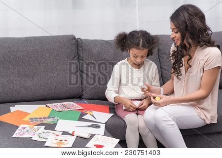 African American Mother And Daughter Gluing Paper For Greeting Card On Mothers Day