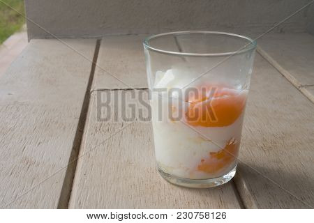Half Cooked Or Half Boiled Or Poached Eggs Served In Clear Glass For Healthy Breakfast Put On Wooden