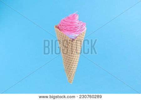 Ice Cream Made Of Colorful Strings In Cone On Blue Pastel Background Minimalistic Concept.