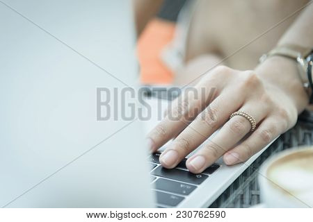 Asian Woman Hands And Married Ring Has Touching And Typing On Laptop Computer With Blurred Coffee, C