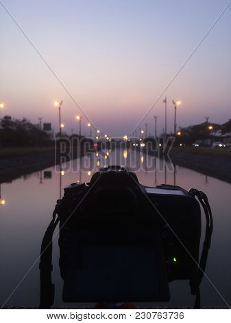 Dslr Camera Shooting On A Cityscape Sunset With Sea Reflection At Utthayan Access Road, Khet Thawi W