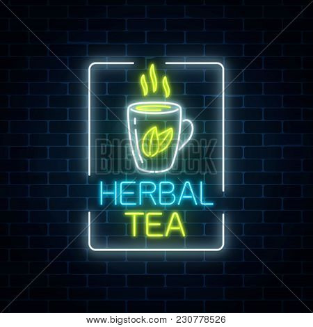 Glowing Neon Cup Of Herbal Tea Sign In Rectangle Frame On Dark Brick Wall Background. Cup Of Green T