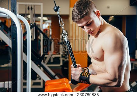 Close-up Of A Young Handsome Man Doing Cable Fly Exercise