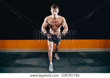 A Young Man Does Hand-cutting On The Simulator In The Gym. Exercise For The Muscles Of The Chest. Cr