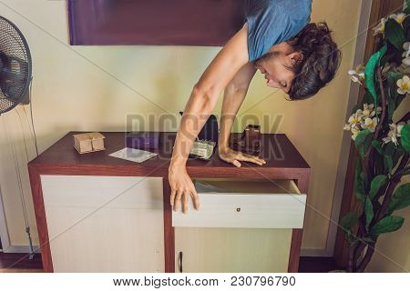 A Man Stands On His Hands Upside Down In The Living Room.
