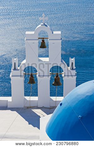 The Three bells of Fira and blue dome, Santorini, Greece, Europe.