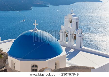 The Three bells of Fira and blue dome, Santorini, Greece, Europe.