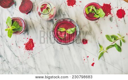 Fresh Morning Beetroot Smoothie Or Juice In Glasses With Mint Leaves Over Grey Marble Background, Co