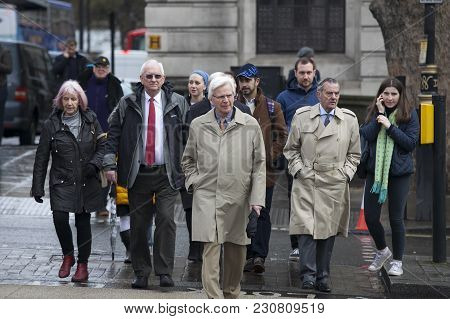 London, England - March 12, 2017 Men Of Middle Age In Cloaks Cross The Road