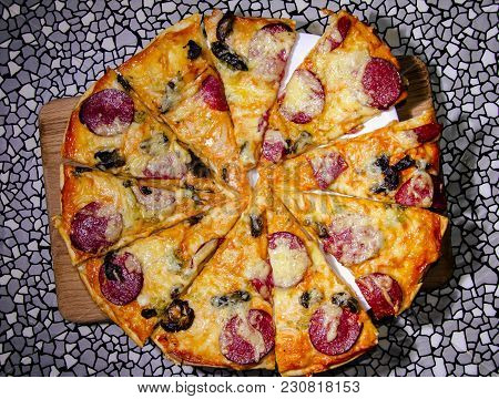 Delicious Top View Of A Pizza On A Wooden Board Against A Gray Texture Background