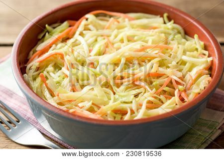 Fresh Coleslow Salad In Bowl On Rustic Wooden Table