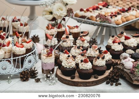 Candybar In A Restaurant. Decorated White Table Fool Of Sweet Pastry. Wedding Sweets.