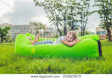 Young Woman Resting On An Air Sofa In The Park.. Lamzac