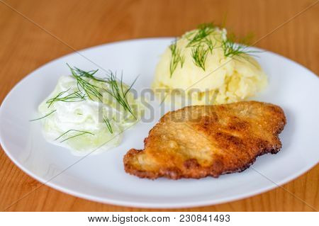Polish Kotlet Schabowy (pork Chop) With Mizeria And Mashed Potatoes.