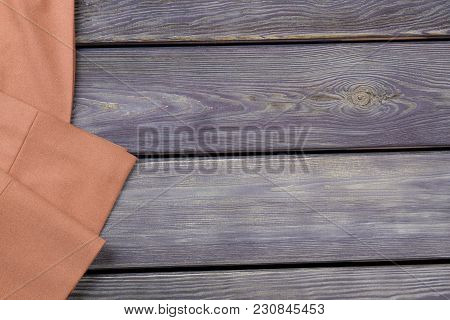 Beige Trouser-leg Close Up. Grey Wooden Surface Background.