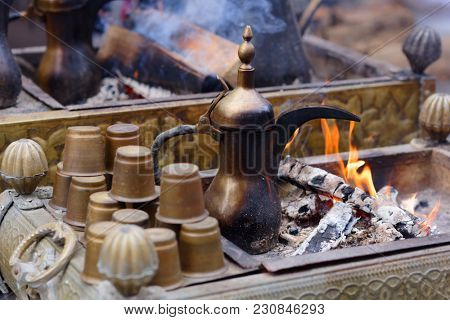 Preparing Oriental coffee in dallah, a traditional Arabic coffee pot