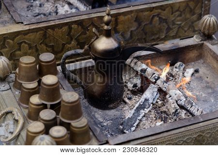 Preparing Oriental coffee in dallah, a traditional Arabic coffee pot
