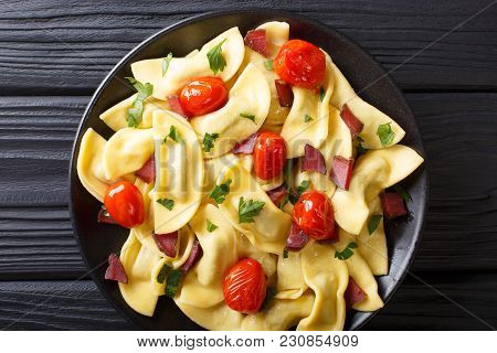 Homemade Dumplings Stuffed With Ham, Cherry Tomatoes And Fresh Herbs Close Up On A Plate On The Tabl