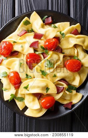 Traditional Italian Pasta Casoncelli With Prosciutto Filling, With Cherry Tomatoes Close-up. Vertica