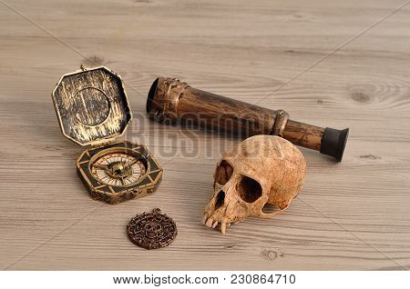 A Compass, Eyeglass And A Pirate Coin For A Pirate Game With A Monkey Skull