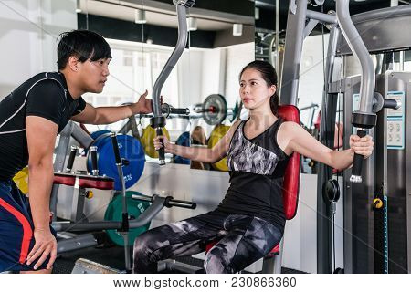 Young Bodybuilder Woman Is Working Out For Chest With The Assistance Of Her Personal Trainer On Butt