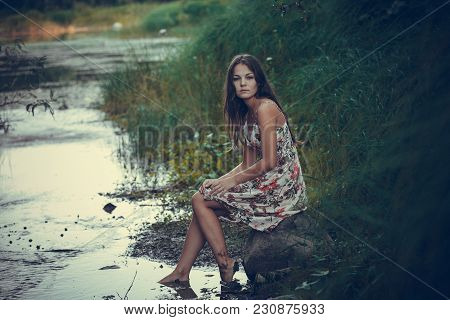 The Young Beautiful Girl, With A Bouquet Of Flowers, Has A Rest And Enjoys Beauty Of The Nature In T