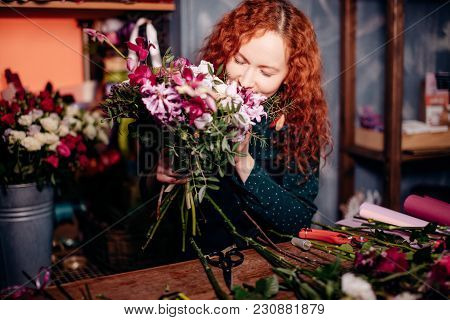 Image Of Good-looking Young Female Closing Eyes And Smelling Bounch. Delectable Flavour. Pleasant Sm
