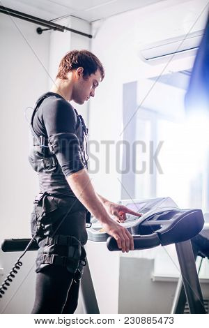 Fit Man In Black Suit For Ems Training Preparing For Running On Treadmill At Gym