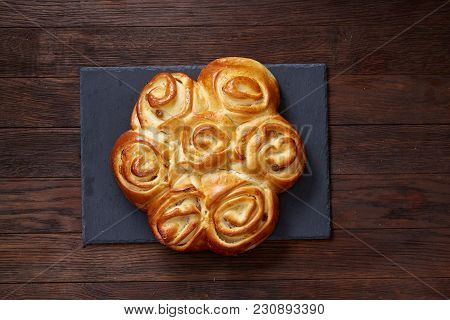 Homemade Rose Bread With Raisins On Black Cutting Board Over Vintage Wooden Background, Close-up, Sh