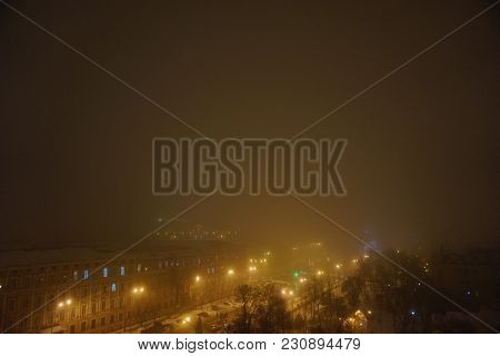 Foggy Evening In Center City. Yellow Street Night Lights. View From Top Roof To Mikhaylovskaya Squar