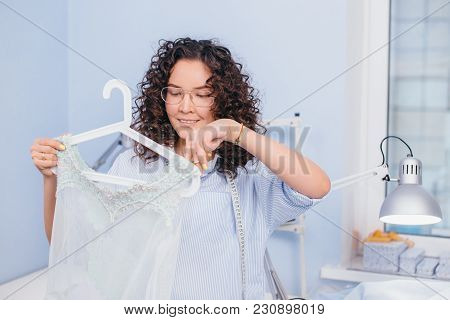 Good-looking Tailor Cutting Beads And Sparkles Of Nightgown. Design Outfit. New Style. Needlwork