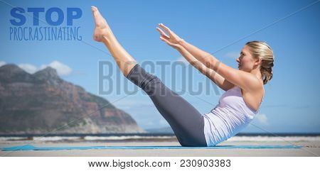 Focused fit blonde doing yoga on the beach against stop procrastinating