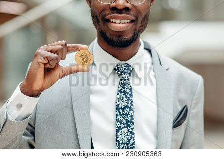 Golden Bitcoin In African Man Hand, Businessman Holding Digitall Symbol Of New Virtual Currency