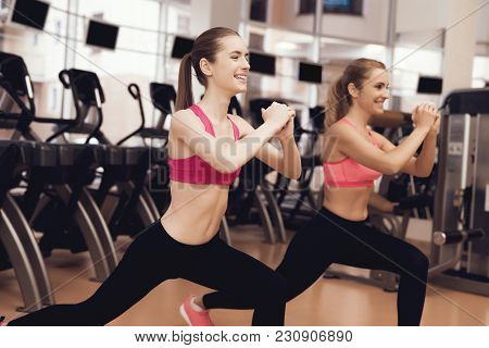 Two Women In Sportswear Doing Aerobical Exercises At The Gym. They Look Happy, Fashionable And Fit.