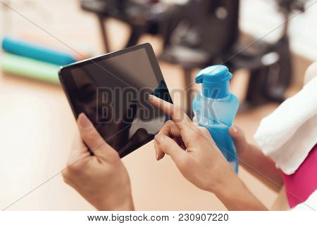 Mother And Daughter In Sportswear Using Tablet At The Gym. They Look Happy, Fashionable And Fit.