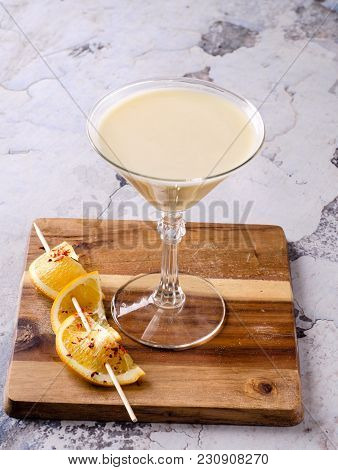 Alcoholic Cocktail - Midori With Rum, Colada, Pineapple And Cream With Ice, Orange Slice In A Martin