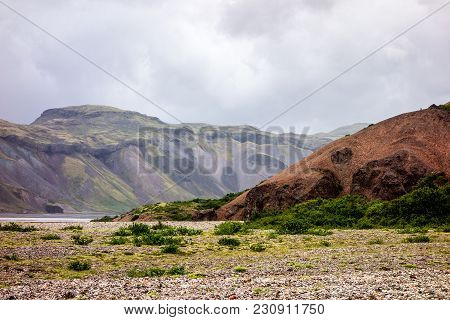 Icelandic Landscape With Red Hills In Lonsoraefi In Cloudy Weather