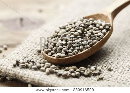 Hemp Seeds In A Rustic Wooden Spoon On The Burlap Napkin, Space For Text