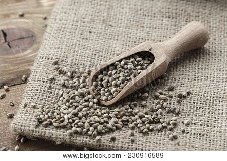 Hemp Seeds In A Rustic Wooden Spoon On The Burlap Napkin, Space For Text