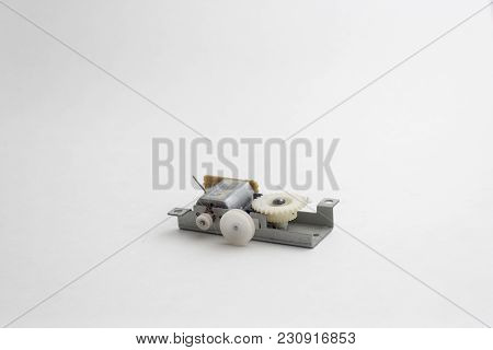 Small Machine Part With Motor, Gears, And Metal