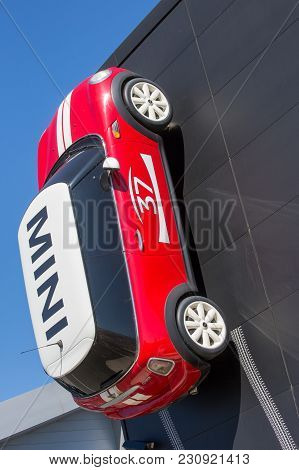 Puilboreau, France - August 7, 2016 : Red Mini Cooper 5 With White Roof Mounted On The Wall Of The B