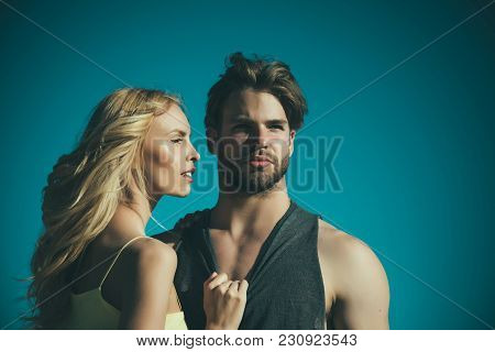 Love And Romance. Couple In Love On Blue Sky Background. Muscular Man And Woman With Long Blond Hair