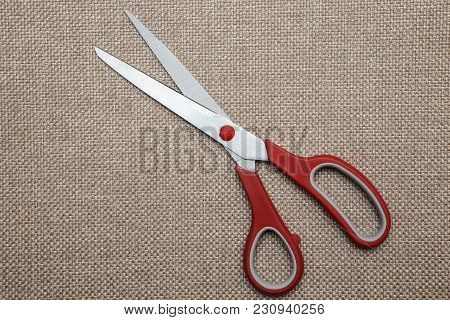 Scisors With Red Plastic Handle. Close Up