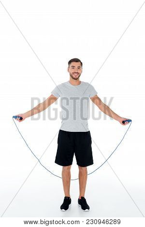 Attractive Sportsman With Jumping Rope Exercising Isolated On White
