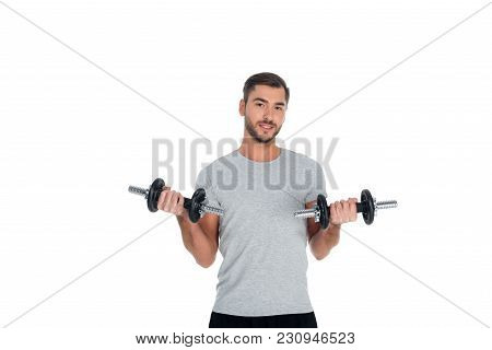 Portrait Of Sportsman Exercising With Dumbbells Isolated On White