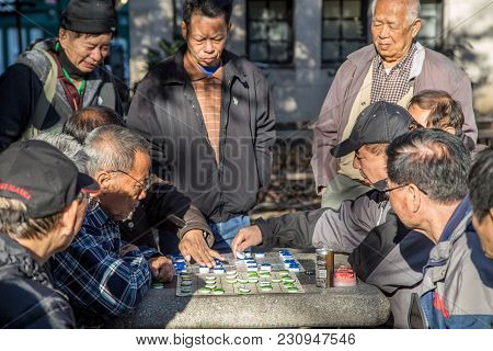 New York, United States Of America - November 17, 2016: Group Of Chinese Men Playing A Board Game In