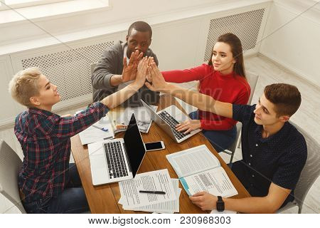 Young Diverse Business People Putting Hands Together At Working Table Background. Successful Startup