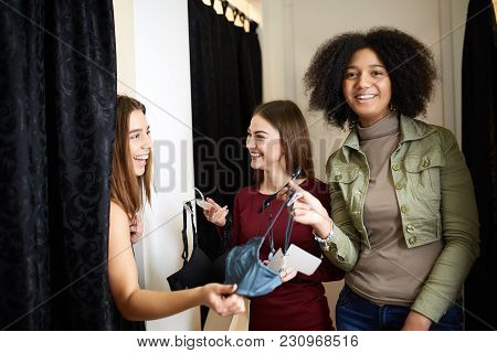 Beautiful Young Woman Asking For A Friends Opinion In The Fitting Room Of Lingerie Store. Female Tri