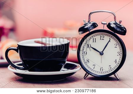 Black Old Clock With Black Coffee Cup Decoration On Wooden Table Pink Colortone
