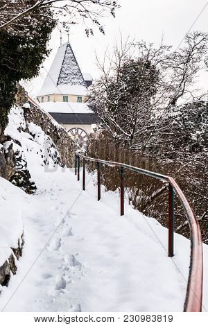 Path To Snow Covered Uhrturm Clocktower Landmark Of City Graz On Hill Schlossberg In Winter